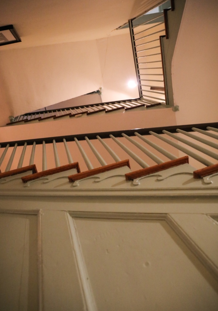 Floors and floors of winding stairs as seen from below inside the Peale Center. 