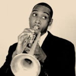 Cam plays his trumpet in a sepia-toned photograph