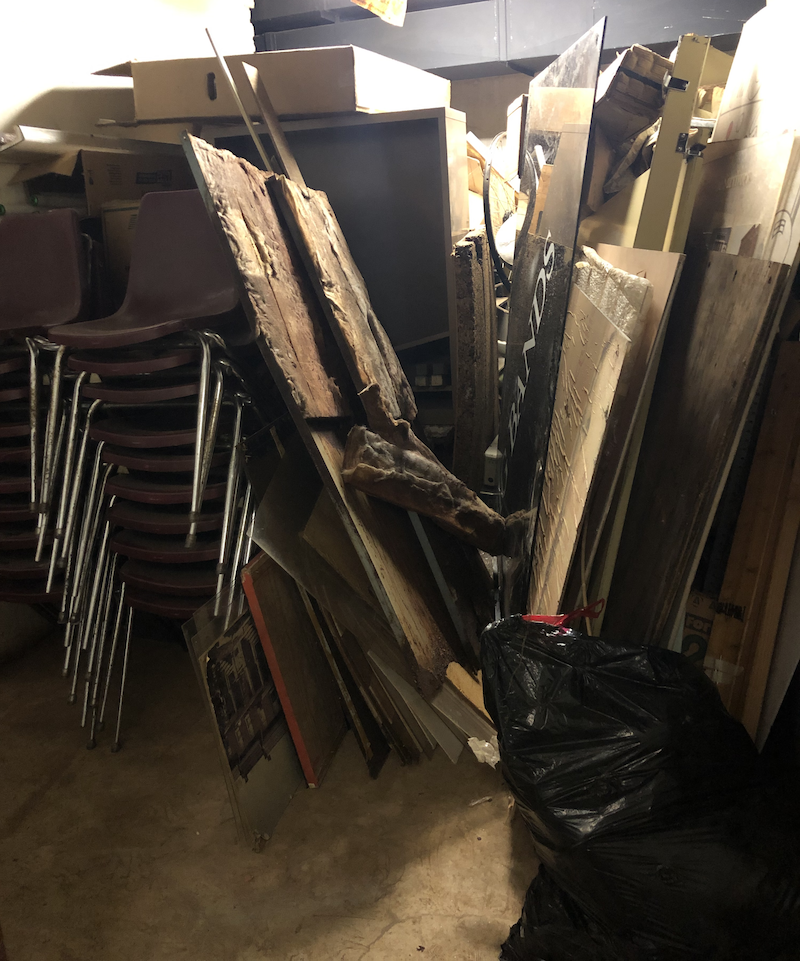 A heap of trash includes lots of cardboard boxes found in the basement of the Peale!