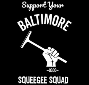 Logo of the "G300 Squeegee Boys": white text on a black background reads "Support your Baltimore Squeegee Squad" with a fist holding a squeegee in silhouette. The image resembles a fist holding a hammer from the tradition of Marxist and labor logos.