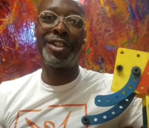 Artist Jeffrey Kent holds up an object he once made for his mother.