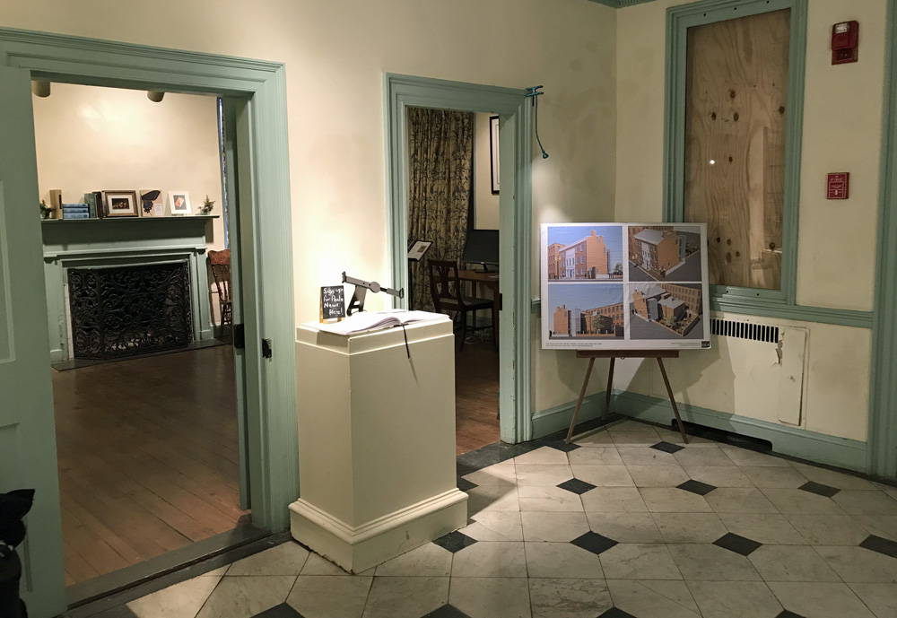 The interior foyer of the Peale building, showing a black and white tiled floor and two doorways.
