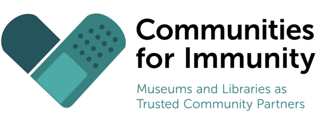 Two teal-colored bandaids in the shape of a heart.