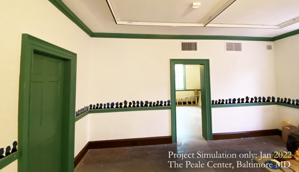 A room in an old house that features a green, wooden chair rail and small portraits along that rail, midway up on the way.
