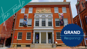 The brick facade of the Peale building along with a blue button that reads, Grand Reopening!